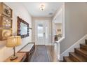 Charming entryway with decorative mirror, console table, stairway and view of the playroom at 3991 Mellon Dr, Odessa, FL 33556