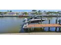 View of the boat dock with lift, providing direct access to the serene waterfront at 413 Islebay Dr, Apollo Beach, FL 33572