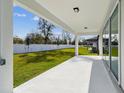 Covered back patio provides the ideal space for outdoor relaxation overlooking the manicured lawn at 4255 Big Sky Dr, Spring Hill, FL 34604