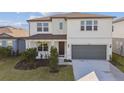 Charming two-story home with a well-maintained lawn, a two-car garage, and inviting curb appeal at 4255 Big Sky Dr, Spring Hill, FL 34604