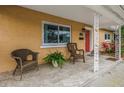 Inviting front porch with tiled floor, wicker chairs, and decorative white columns at 4322 22Nd N Ave, St Petersburg, FL 33713