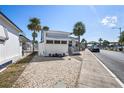 A cozy single-story home with palm trees, a covered porch, and well-maintained landscaping at 4851 W Gandy Blvd # B7L9, Tampa, FL 33611