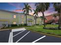 Charming two-story townhouse featuring white shutters, mature palms, and manicured landscaping at 4966 Coquina Key Se Dr # 4966, St Petersburg, FL 33705