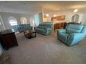 Spacious living room featuring a carpet, neutral-colored walls, and open archways at 6283 Lorraine Ln, Spring Hill, FL 34608