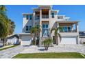 Modern two-story home with landscaped front yard, featuring a double garage and contemporary architectural design at 6976 S Shore S Dr, St Petersburg, FL 33707