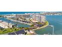 Aerial view featuring condos, boat docks, and waterfront property in a coastal community at 1 Key Capri # 604W, Treasure Island, FL 33706