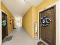 Hallway view with unit doors, welcome signs, and an open balcony at 10017 Courtney Palms Blvd # 301, Tampa, FL 33619