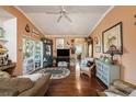Inviting living room with hardwood floors and a sliding door to a sunroom at 10017 Courtney Palms Blvd # 301, Tampa, FL 33619