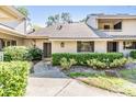 Charming condo showcasing tidy landscaping and a welcoming walkway at 102 Old Mill Pond Rd, Palm Harbor, FL 34683