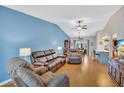 Bright living room with vaulted ceiling, modern furniture, and open layout to dining and kitchen at 11430 94Th St, Largo, FL 33773