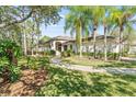 Beautiful home with lush landscaping, mature trees, and a well-maintained lawn creating a serene and inviting curb appeal at 12227 Glencliff Cir, Tampa, FL 33626