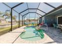 Screen-enclosed pool area featuring a uniquely designed pool, comfortable lounge seating, and lush landscaping for relaxation at 12749 Weatherstone Dr, Spring Hill, FL 34609