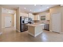Well-lit kitchen with stainless steel appliances, light-colored cabinets, and a convenient center island at 13574 Circa Crossing Dr, Lithia, FL 33547