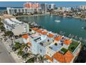 Aerial view showcases the condo's rooftop amenities with colorful buildings and waterfront views at 140 Brightwater Dr # 1, Clearwater Beach, FL 33767