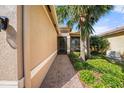 Attractive front of a single-story home with a brick-paved walkway and screened in entryway at 15908 Cobble Mill Dr, Wimauma, FL 33598