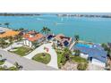 Breathtaking aerial view of waterfront property with solar panels, luxurious homes and serene ocean vistas at 173 1St W St, Tierra Verde, FL 33715