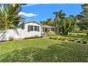 Beautiful home featuring a lush green lawn, tasteful landscaping, and charming architectural details at 209 17Th N Ave, St Petersburg, FL 33704