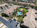 Community aerial view showcasing a pool, landscaping, and organized parking in a well-maintained neighborhood at 2537 Gloriosa Dr # 2, Palm Harbor, FL 34684