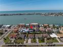 Aerial view of the blue home's location with waterfront views of the inter coastal waterway, and boat in view at 289 8Th N Ave, Tierra Verde, FL 33715