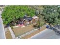 Stripped home features wood frame, no roof, sits on a corner lot near a street at 3601 N 18Th St, Tampa, FL 33605