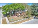 Stripped home features wood frame, no roof, sits on a corner lot with a street sign at 3601 N 18Th St, Tampa, FL 33605