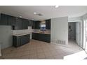 Spacious kitchen featuring dark green cabinets, white subway tile backsplash, and light countertops at 4501 67Th N St, St Petersburg, FL 33709