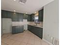 Open kitchen area offering ample counter space with dark green cabinets and modern fixtures at 4501 67Th N St, St Petersburg, FL 33709
