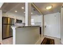 Well-lit kitchen with stainless steel appliances and granite countertops, adjacent to the entry door at 4750 Cove Cir # 604, St Petersburg, FL 33708