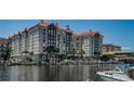 Beautiful waterfront condo building showcasing private boat slips, landscaping, and architectural details at 700 S Harbour Island Blvd # 204, Tampa, FL 33602