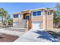Beautiful house with a grand staircase leading to the entrance and attached garages at 733 Seminole Blvd, Tarpon Springs, FL 34689