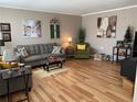 Cozy living room featuring a comfortable gray sofa, hardwood floors, and stylish decor at 8220 112Th St # 202, Seminole, FL 33772