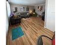 Spacious living room featuring hardwood floors, gray sofas, and stylish decor at 8220 112Th St # 202, Seminole, FL 33772