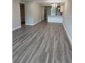 Inviting living space featuring wood floors and an open layout that connects to the modern kitchen and chandelier at 1000 49Th N St # 309, St Petersburg, FL 33710