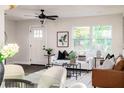 Bright and inviting living room with white sofa, stylish decor, and natural light at 1008 E Norfolk St, Tampa, FL 33604