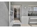 Inviting entryway featuring tile floors, neutral paint, and a glimpse into the home's interior at 12041 Hoosier Ct # 104, Hudson, FL 34667