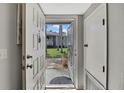 Warm welcome: Bright entryway view showcasing outdoor landscaping and nearby building at 12041 Hoosier Ct # 104, Hudson, FL 34667