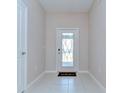 Bright foyer features decorative glass front door, neutral paint, and tile flooring at 14477 Editors Note St, Ruskin, FL 33573