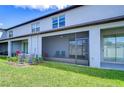 A screened-in back patio with ceiling fan, outdoor seating, and a view of the backyard at 14477 Editors Note St, Ruskin, FL 33573