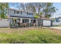 Charming two-story home features a well-maintained lawn, a two-car garage, and colorful front flowerbeds at 15802 Knollview Dr, Tampa, FL 33624