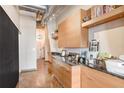 Stylish home office area featuring a long counter with drawers, open shelves, and exposed ceiling pipes at 175 2Nd S St # 1014, St Petersburg, FL 33701