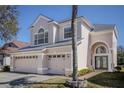 Stunning two-story home with a three-car garage, arched entryway, and professionally landscaped front yard at 17923 Timber View St, Tampa, FL 33647