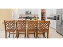 Kitchen island with seating area and stainless steel appliances at 17950 Beaming Rays Ln, Lutz, FL 33558
