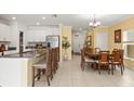Open floor plan featuring a kitchen with white cabinets and stainless steel appliances at 17950 Beaming Rays Ln, Lutz, FL 33558