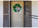 Charming condo door with a decorative wreath, enhancing the welcoming atmosphere at 19029 Us Highway 19 N # 2-17, Clearwater, FL 33764