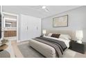 Serene bedroom with a king-size bed, minimalist decor, and a view into the ensuite bathroom at 1972 Sourwood Blvd, Dunedin, FL 34698