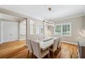 Elegant dining room featuring hardwood floors, modern lighting fixture, and multiple windows at 2280 Mackenzie Ct, Clearwater, FL 33765