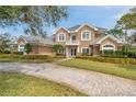 Elegant two-story home with a beautiful brick driveway and a charming front balcony at 2280 Mackenzie Ct, Clearwater, FL 33765
