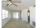 Spacious living room with large windows, sliding glass doors, and neutral carpeting at 24862 Us Highway 19 N # 2801, Clearwater, FL 33763
