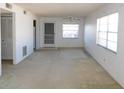 Bright living room featuring neutral carpeting, a ceiling fan, and two large windows at 24862 Us Highway 19 N # 2801, Clearwater, FL 33763