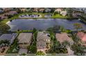 Aerial view of homes nestled around a serene lake, showcasing the community's tranquil setting and attractive residential architecture at 2665 Lakebreeze N Ln, Clearwater, FL 33759